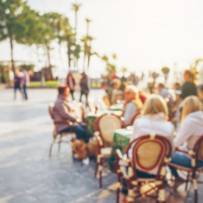 People sitting on a terrace  in a well organised city,