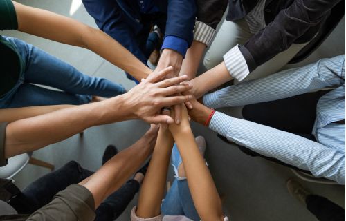 Hands together in a circle to represent collaboration in the UNCHAIN project.