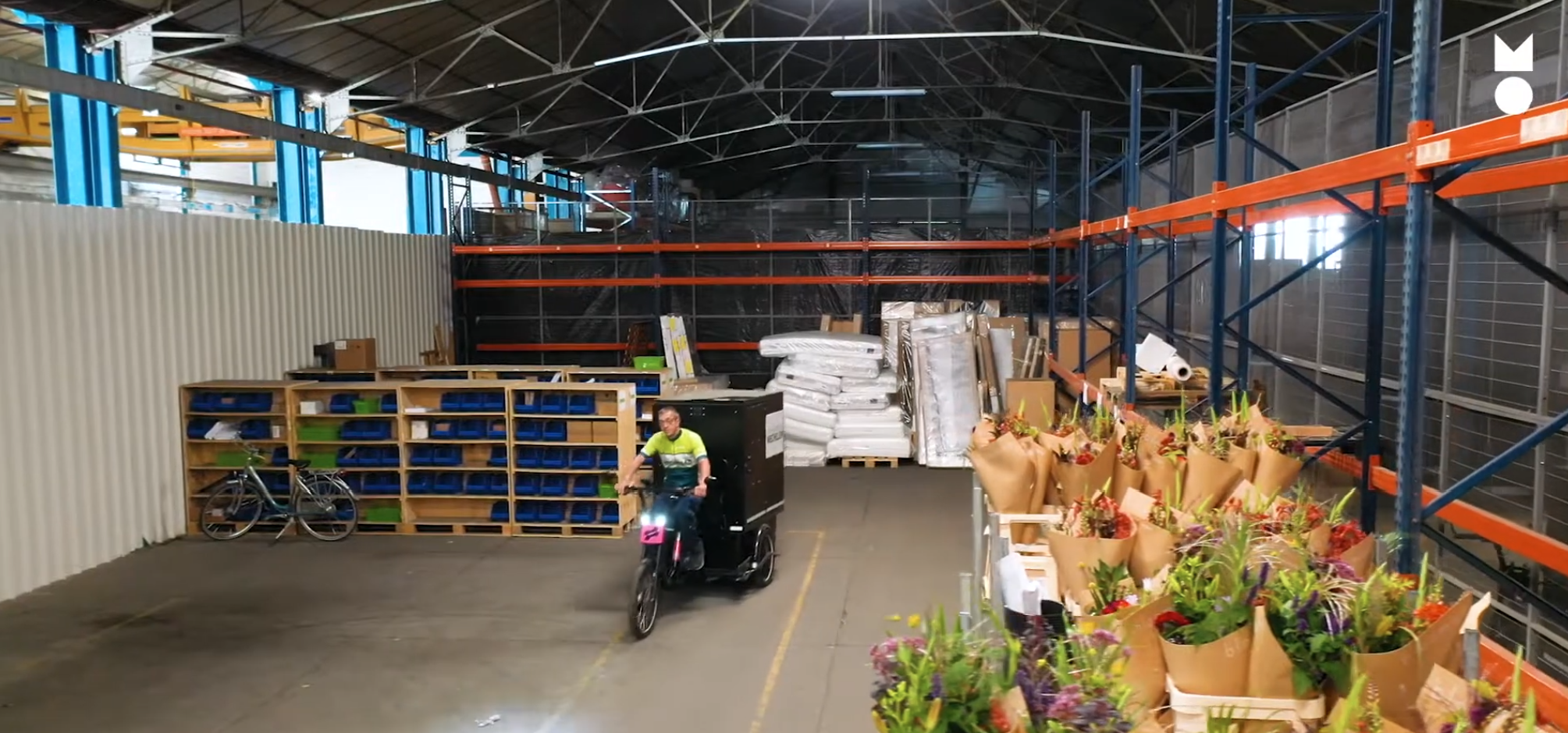 man on a cargo bike in a storage building